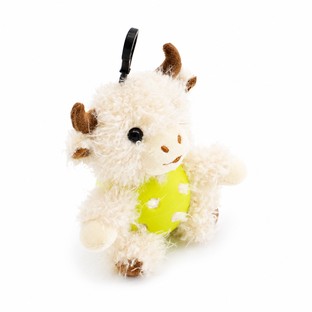 A plush white highland cow toy inside an yellow pickleball, attached to a black key ring, photographed on a clean white background.