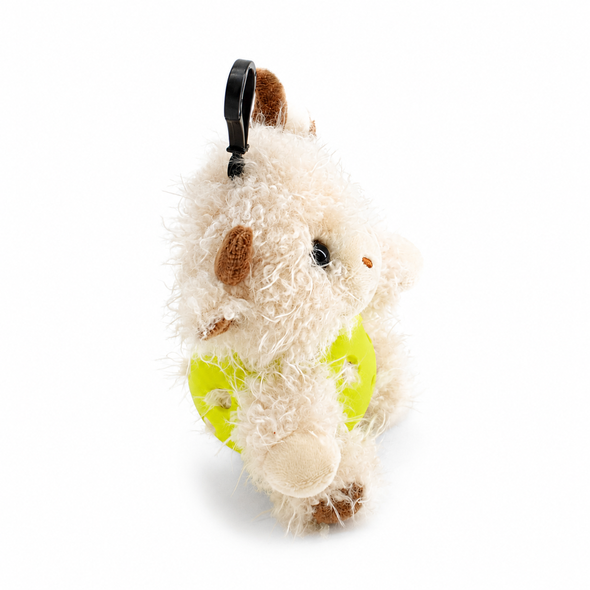 A plush white highland cow toy inside an yellow pickleball, attached to a black key ring, photographed on a clean white background.