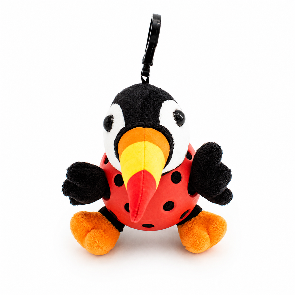 A plush toucan toy inside a red pickleball, attached to a black key ring, photographed on a clean white background.