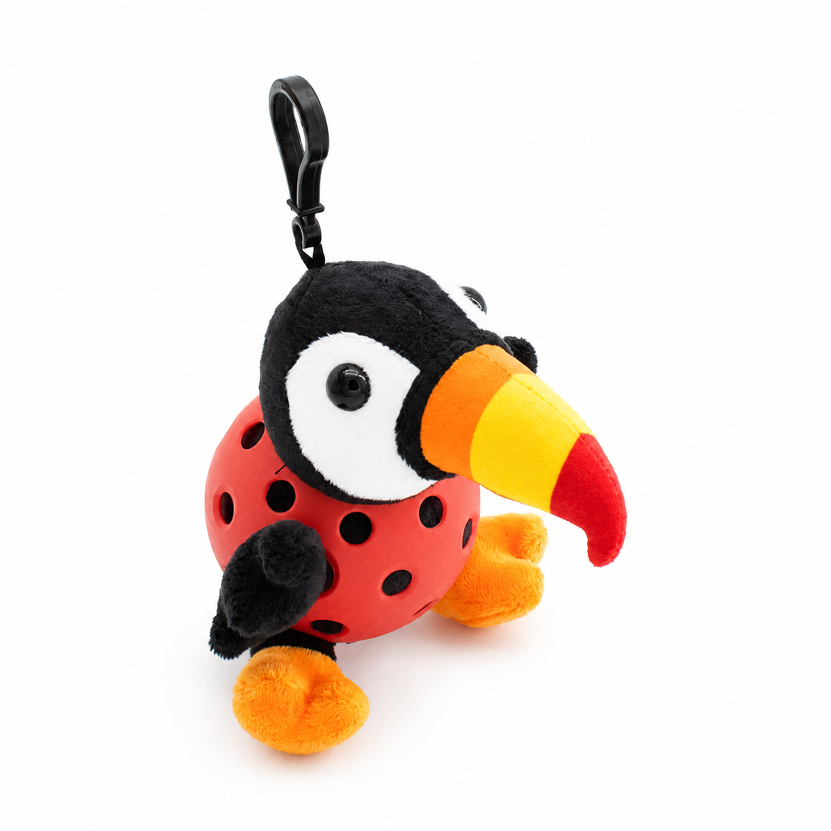 A plush toucan toy inside a red pickleball, attached to a black key ring, photographed on a clean white background.