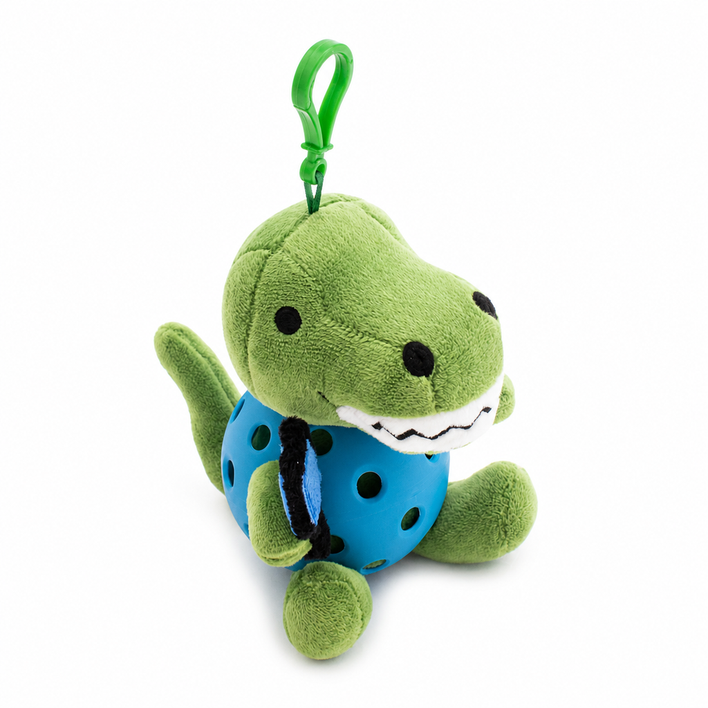 A plush T-rex toy inside a blue pickleball, attached to a green key ring, photographed on a clean white background.