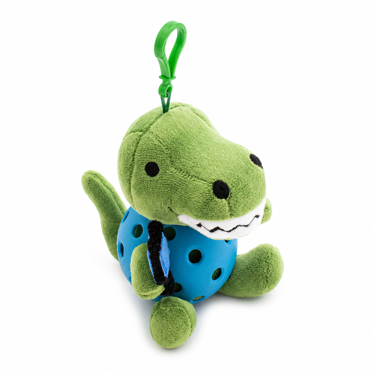 A plush T-rex toy inside a blue pickleball, attached to a green key ring, photographed on a clean white background.
