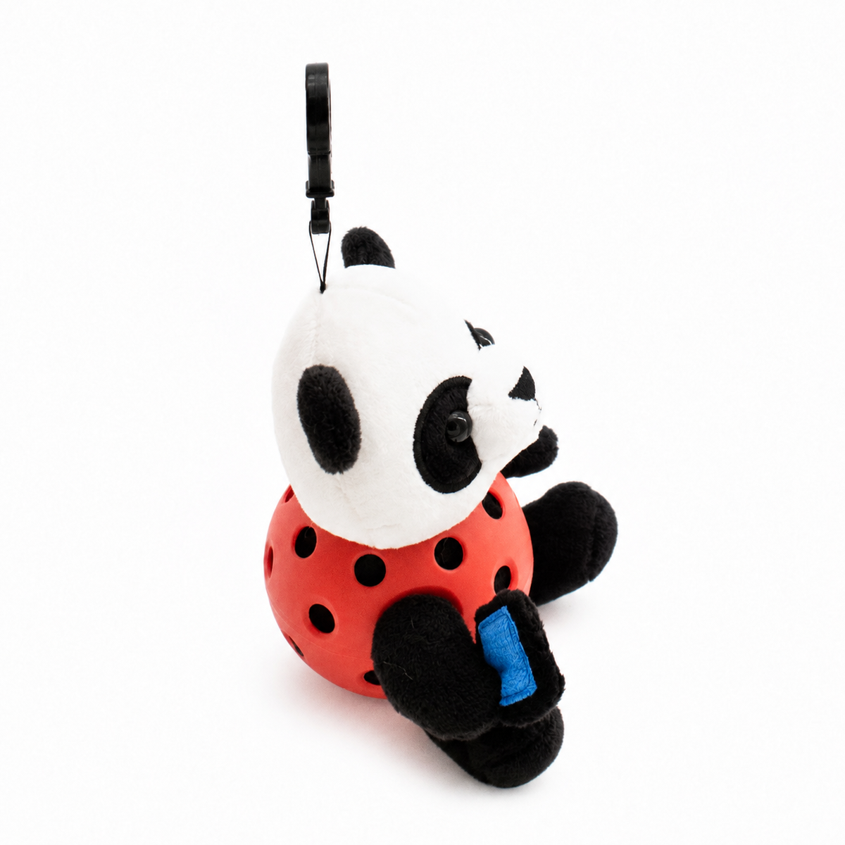 A plush panda toy inside an red pickleball, attached to a black key ring, photographed on a clean white background.