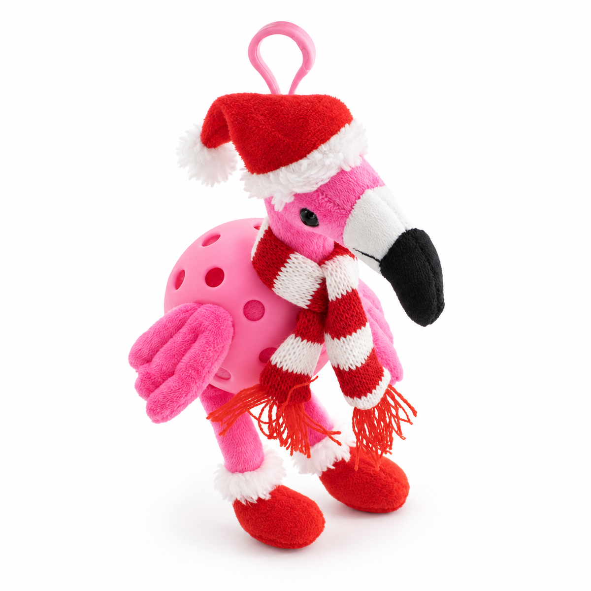 A pink plush flamingo toy with a Santa hat, red and white striped scarf, and red boot covers, photographed on a clean white background.
