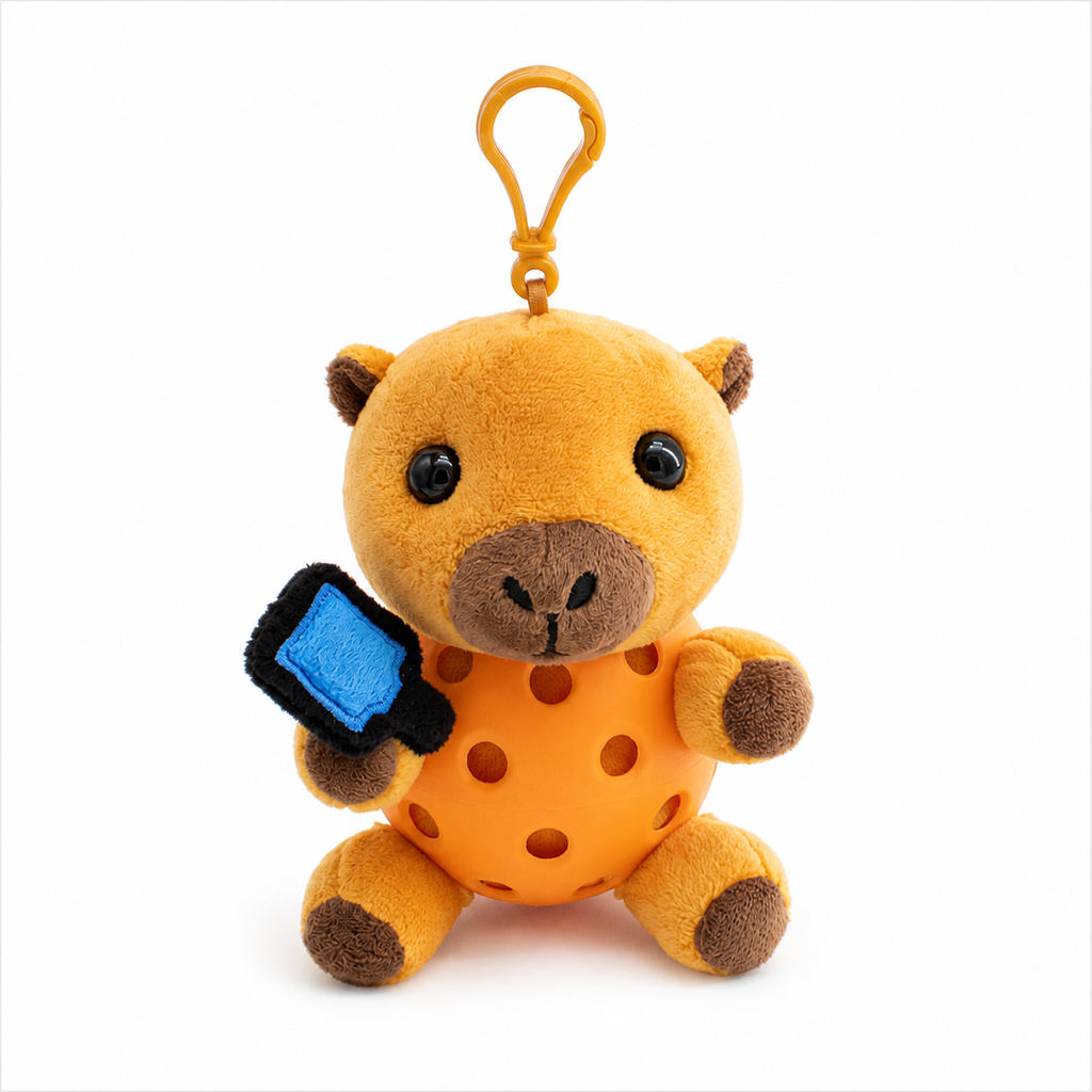 A plush capybara toy inside a orange pickleball, attached to a orange key ring, photographed on a clean white background.