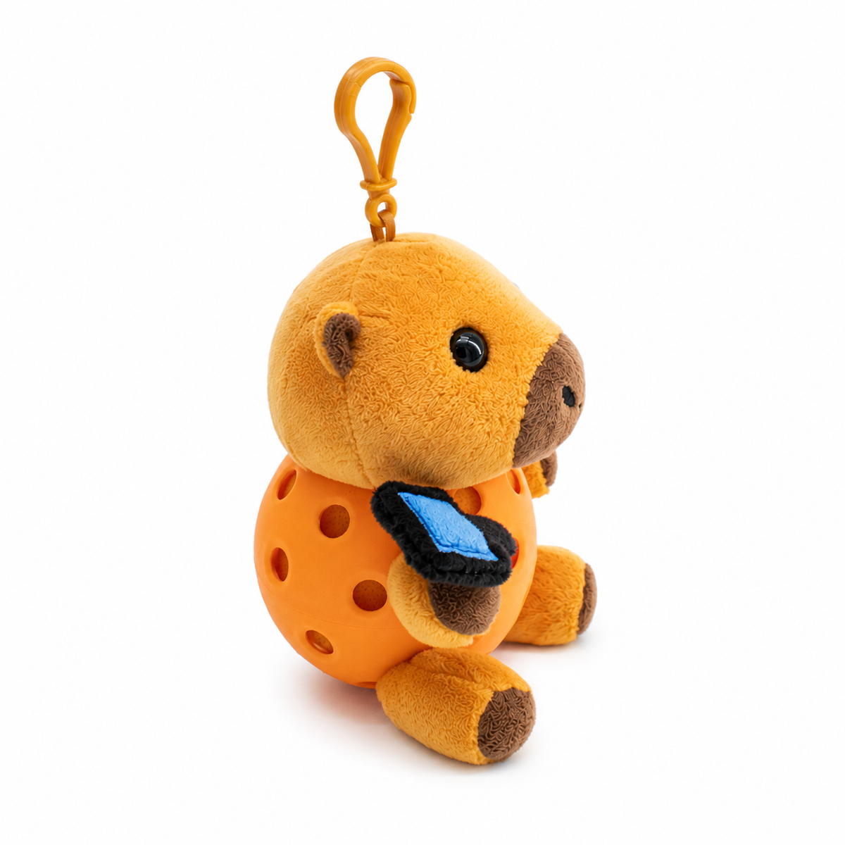 A plush capybara toy inside a orange pickleball, attached to a orange key ring, photographed on a clean white background.